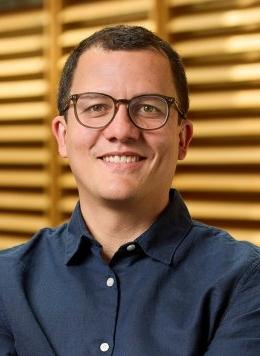 portrait of andres fernandez wearing glasses and a navy blue button up shirt